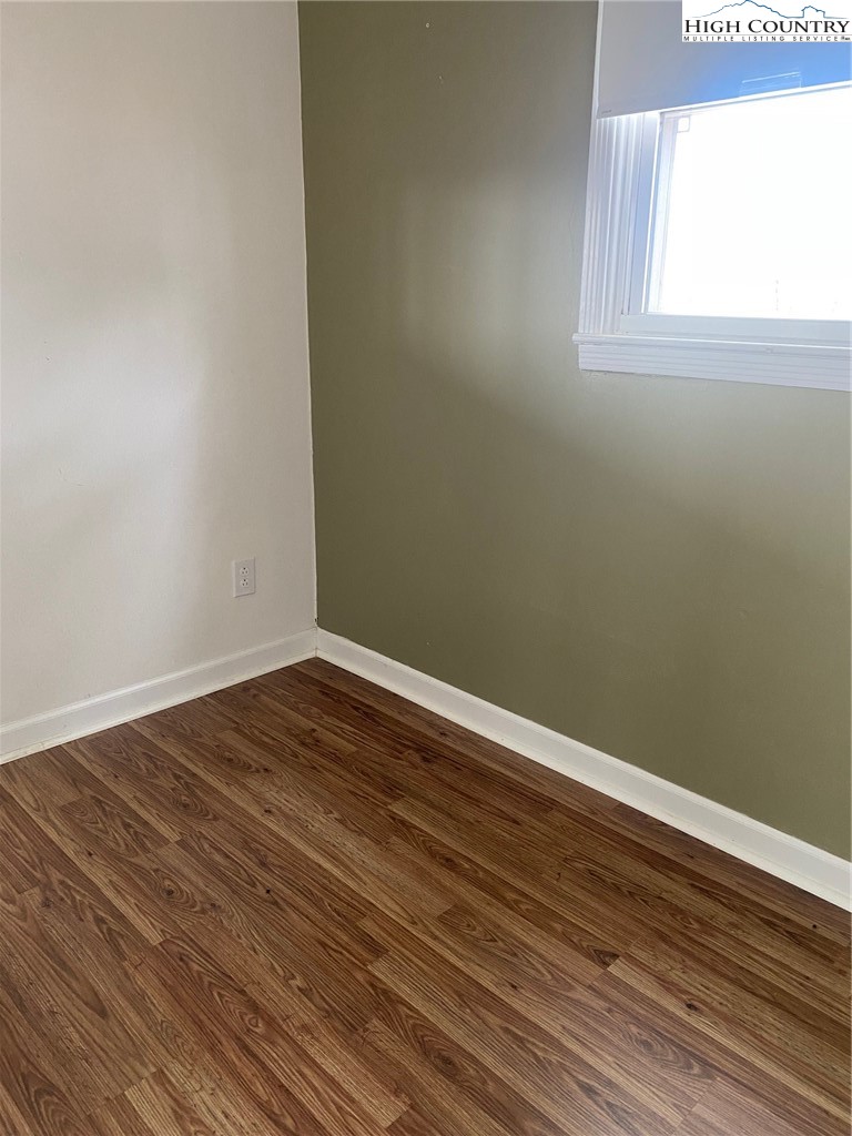1345 Wagoner Ridge Road Ennice, NC 28623 - Photo 5 of 48 a view of a room with wooden floor and windows