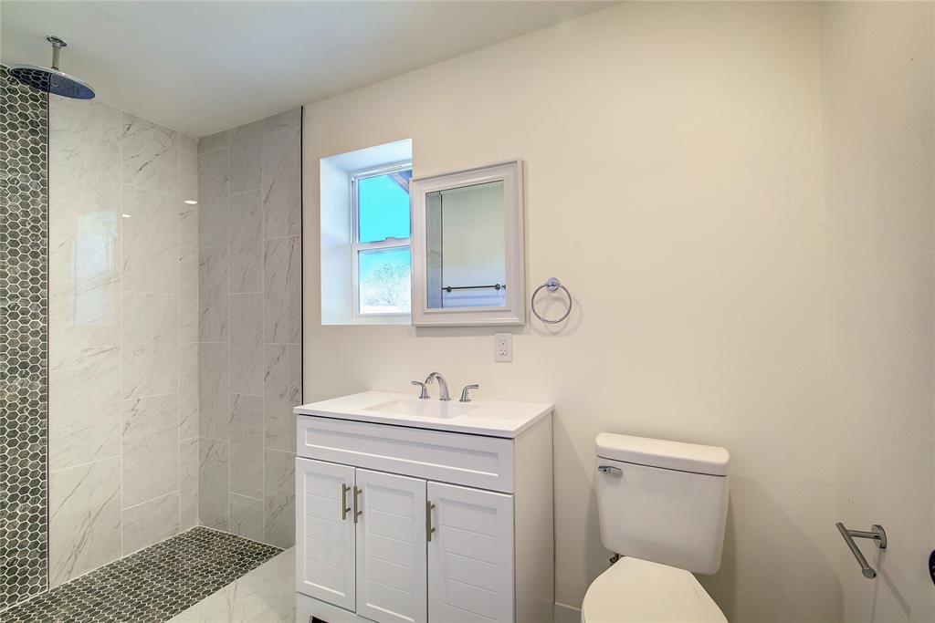 520 North 1st Street Point, TX 75472 - Photo 21 of 34 a bathroom with a sink toilet and vanity