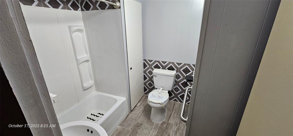 407 Pecan Street Clyde, TX 79510 - Photo 16 of 40 a bathroom with a bathtub and a shower