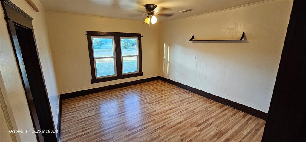 407 Pecan Street Clyde, TX 79510 - Photo 18 of 40 a view of empty room with wooden floor and fan