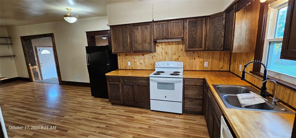 407 Pecan Street Clyde, TX 79510 - Photo 25 of 40 a kitchen with wooden cabinets and a sink