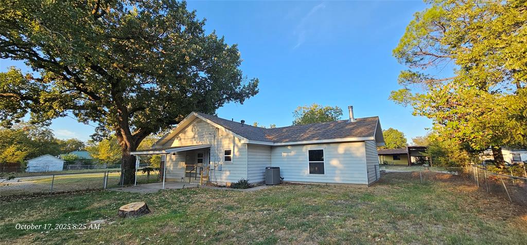 407 Pecan Street Clyde, TX 79510 - Photo 35 of 40 a front view of a house with a yard and garage