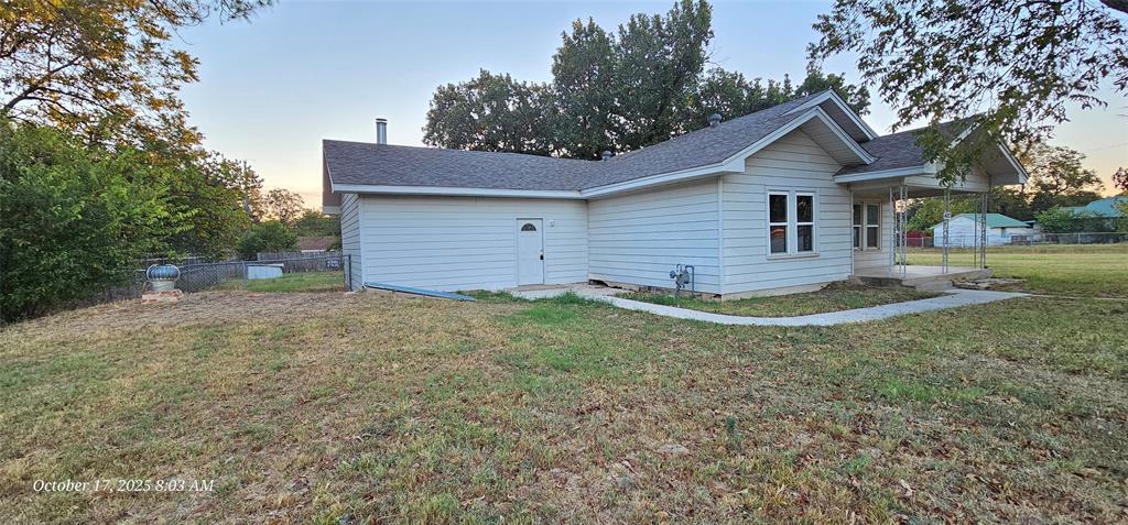 407 Pecan Street Clyde, TX 79510 - Photo 6 of 40 a view of a house with a yard and large tree