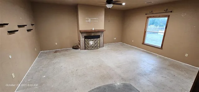 a view of an empty room with a fireplace