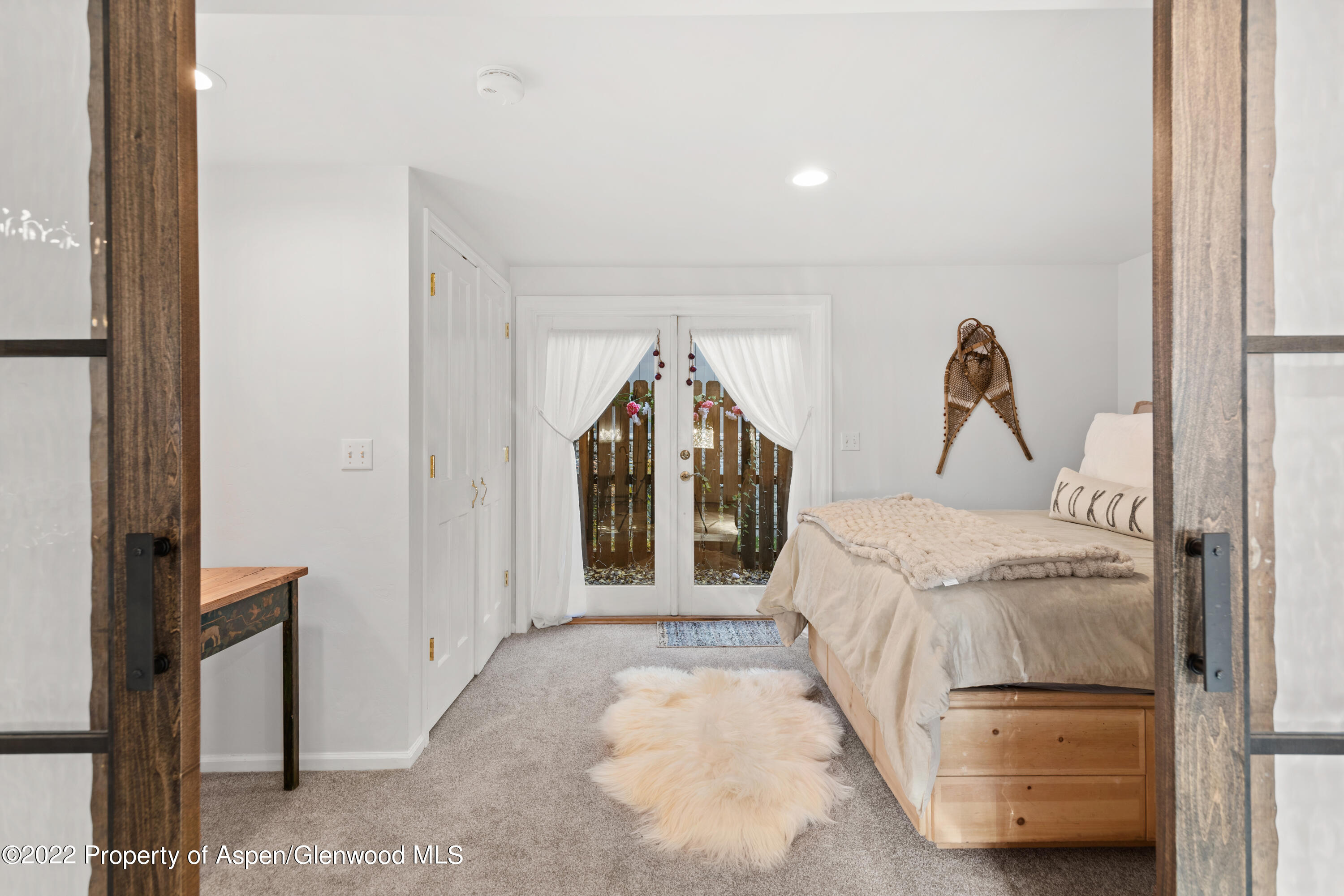 950 East Durant Avenue, Unit 2 Aspen, CO 81611 - Photo 11 of 14 a bedroom with a bed and a window