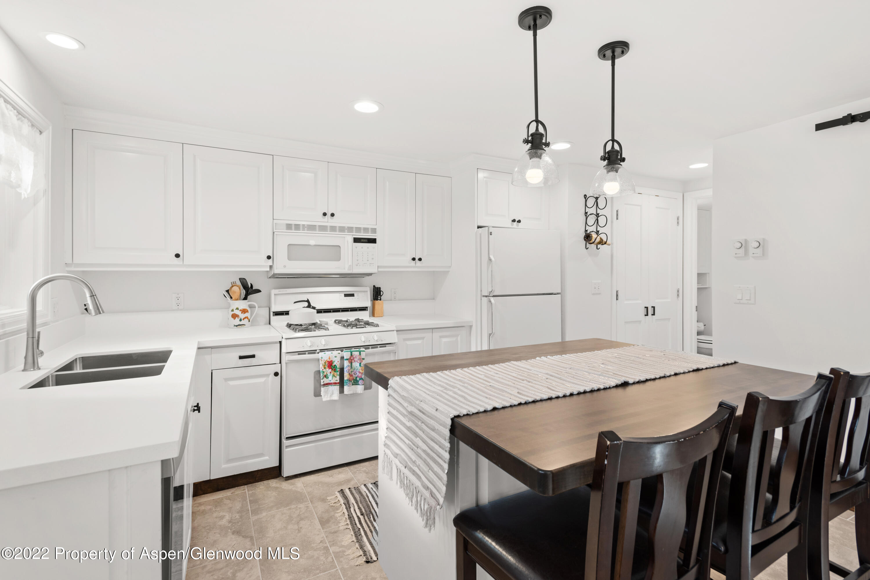950 East Durant Avenue, Unit 2 Aspen, CO 81611 - Photo 4 of 14 a kitchen that has a cabinets a sink stainless steel appliances and cabinets