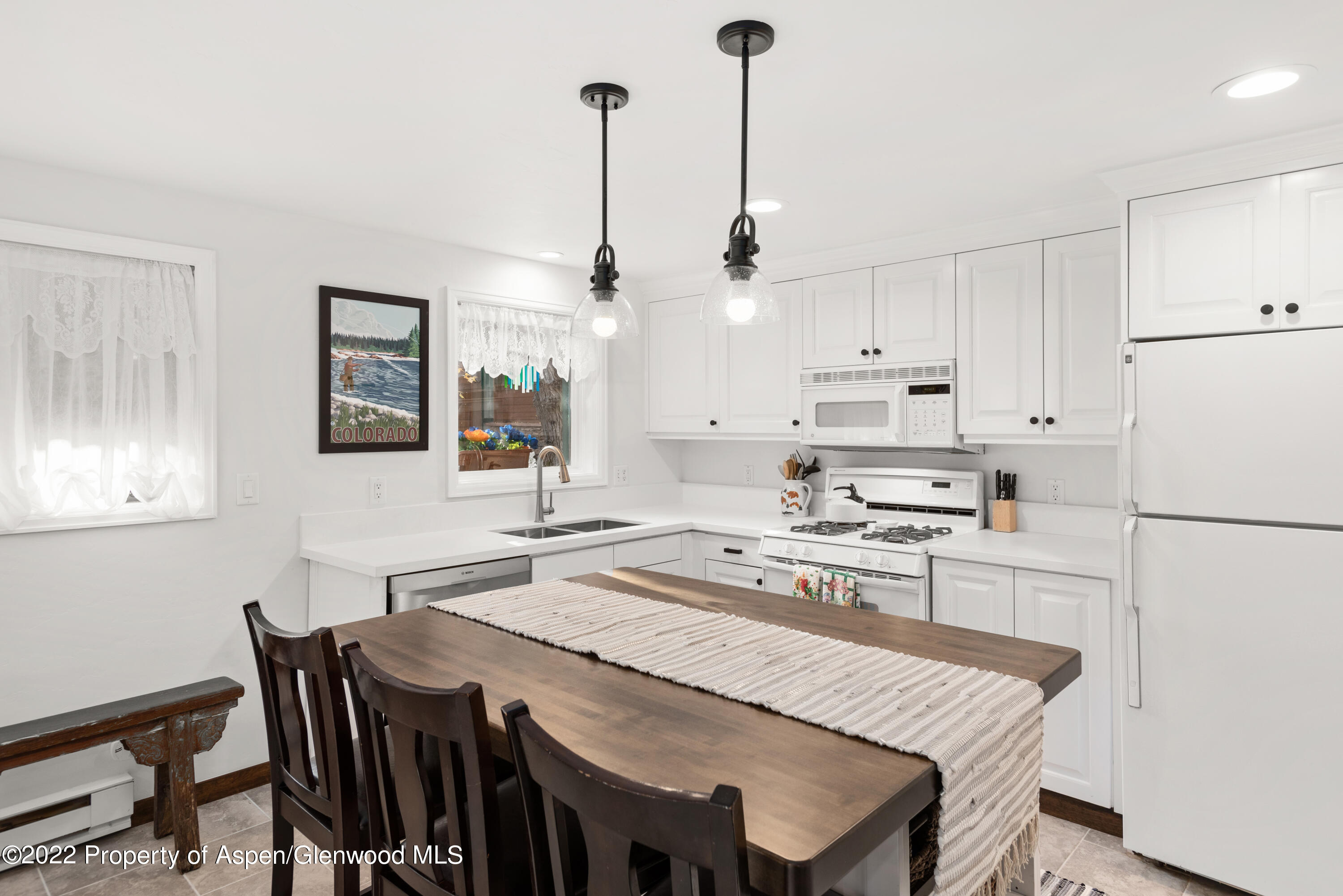 950 East Durant Avenue, Unit 2 Aspen, CO 81611 - Photo 5 of 14 a kitchen with appliances cabinets and wooden floor
