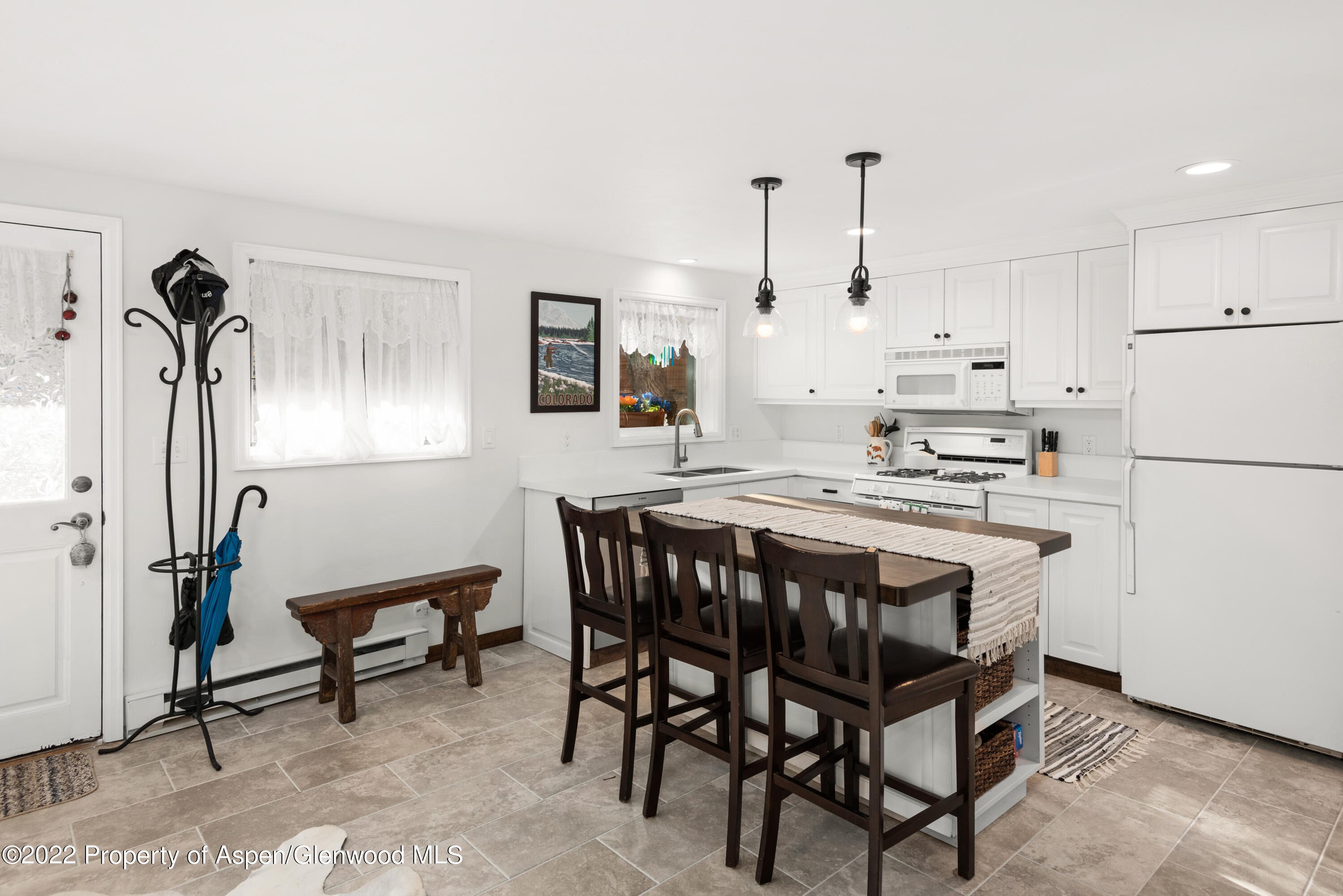 950 East Durant Avenue, Unit 2 Aspen, CO 81611 - Photo 6 of 14 a kitchen with stainless steel appliances granite countertop a sink a stove a refrigerator and white cabinets