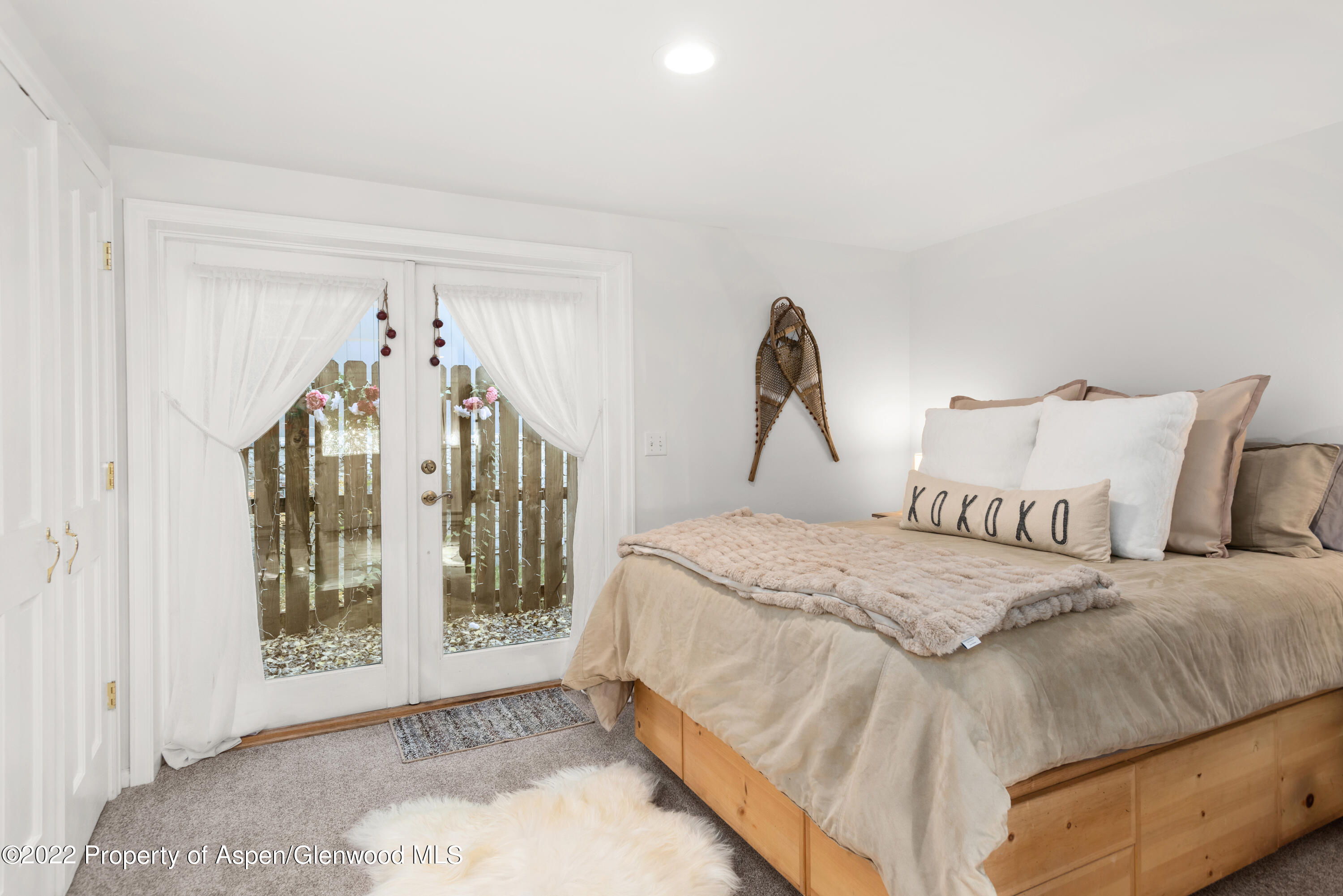 950 East Durant Avenue, Unit 2 Aspen, CO 81611 - Photo 10 of 14 a bedroom with a bed and a window