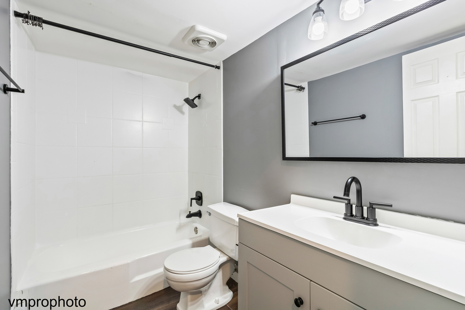 2323 South Goebbert Road, Unit F109 Arlington Heights, IL 60005 - Photo 6 of 11 a bathroom with a sink a toilet and a mirror