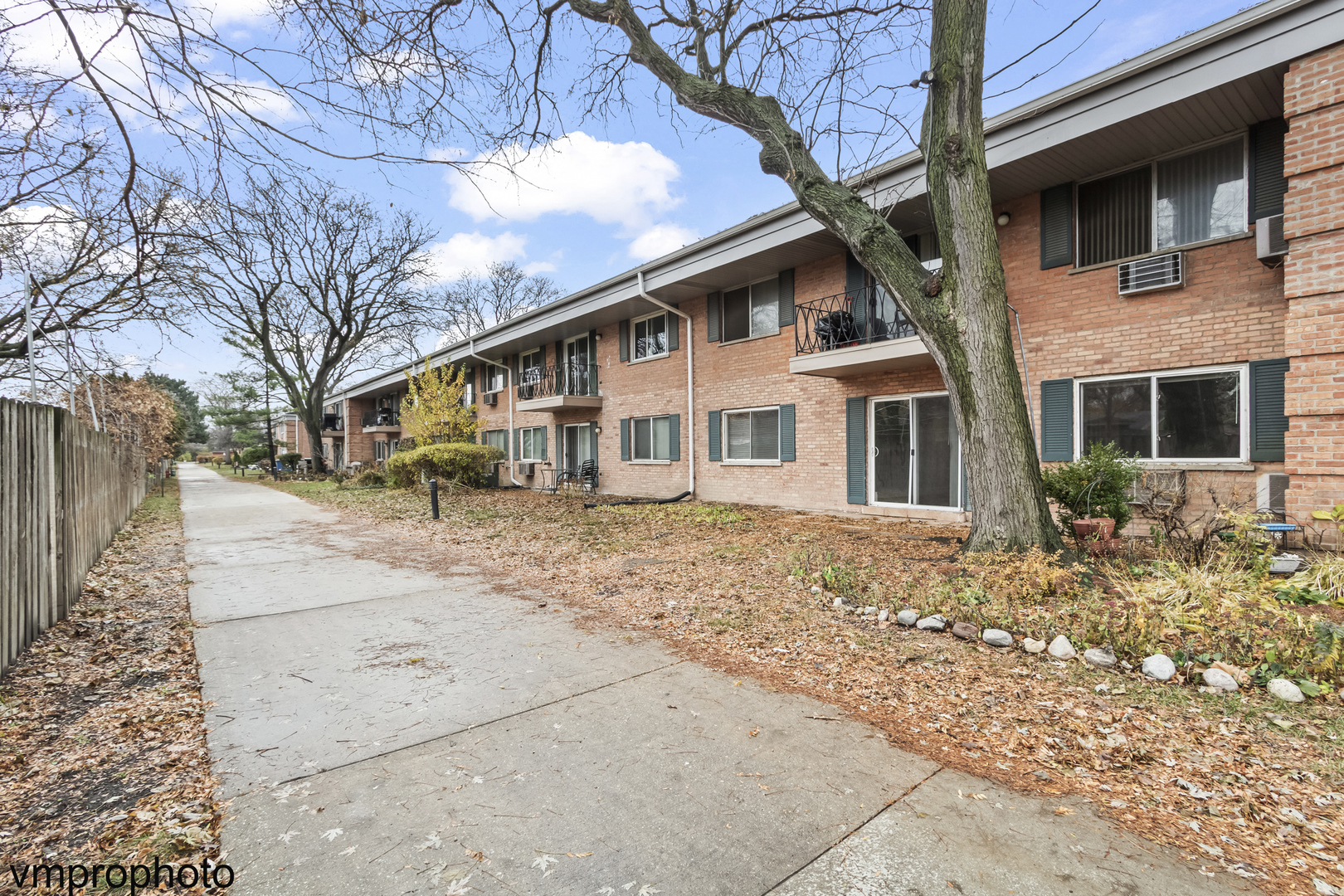2323 South Goebbert Road, Unit F109 Arlington Heights, IL 60005 - Photo 10 of 11 a front view of a house with a yard