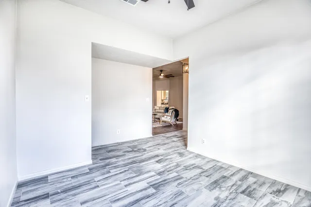 a view of a room with wooden floor