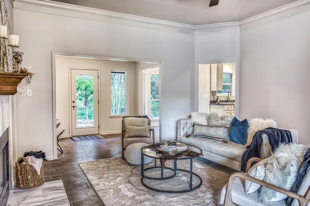 a living room with furniture and wooden floor