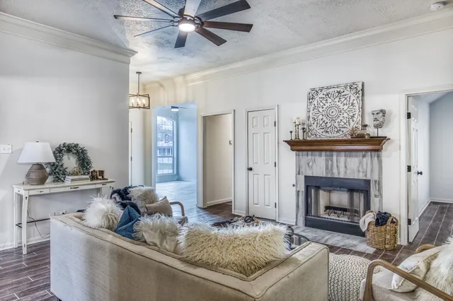 a living room with furniture and a fireplace