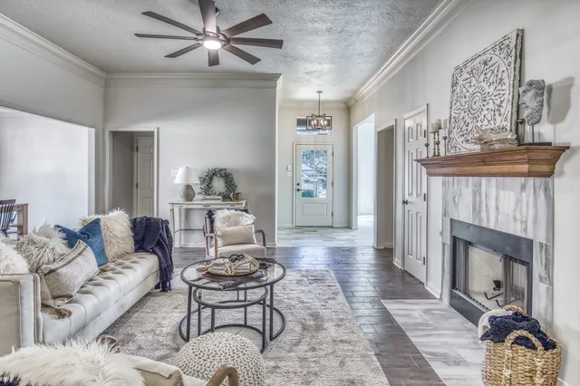a living room with furniture and a fireplace