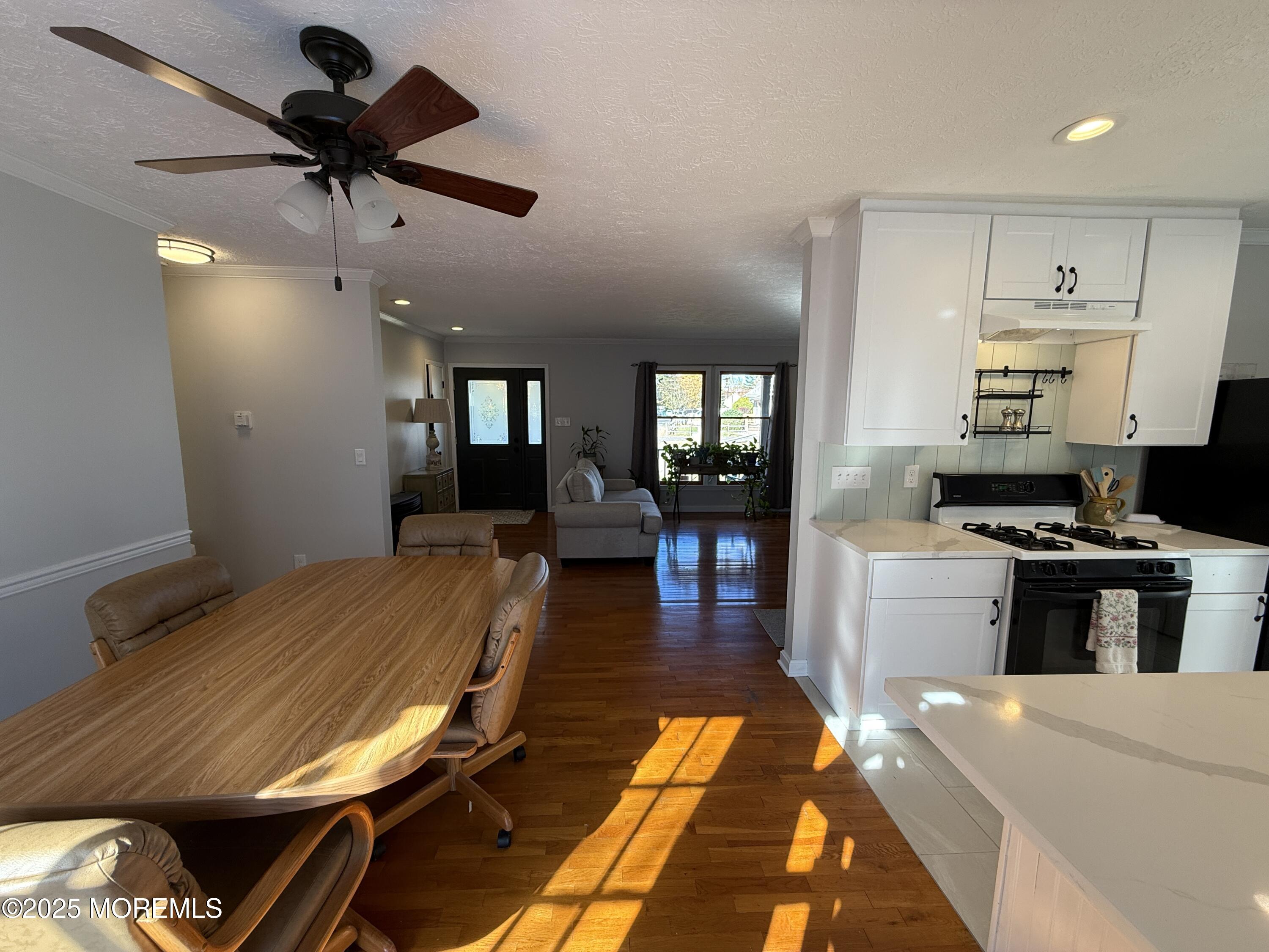 220 B Center Street Tuckerton, NJ 08087 - Photo 14 of 54 a kitchen with kitchen island stainless steel appliances sink stove dining table and chairs