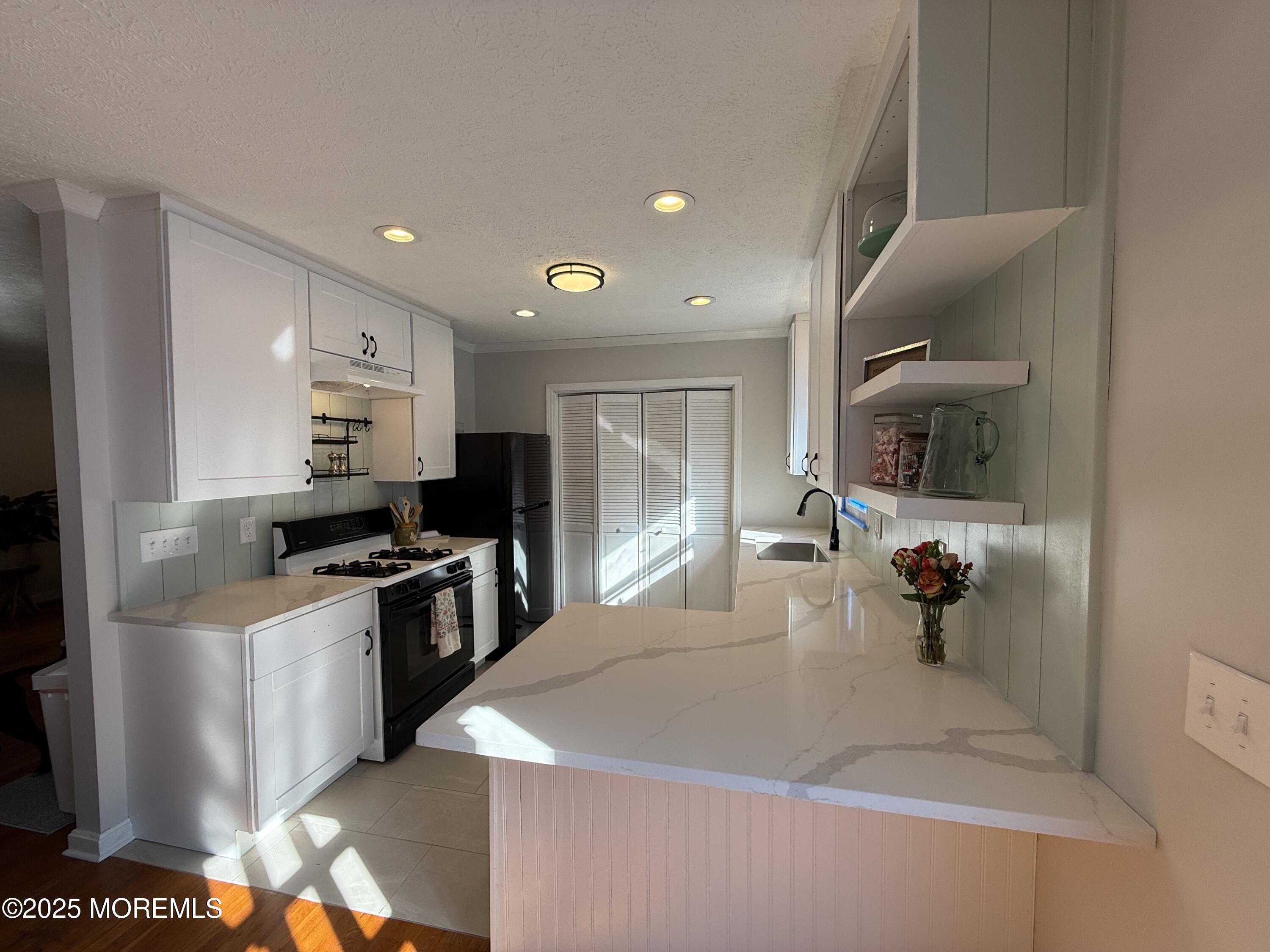 220 B Center Street Tuckerton, NJ 08087 - Photo 15 of 54 a kitchen with stainless steel appliances granite countertop a sink and stove