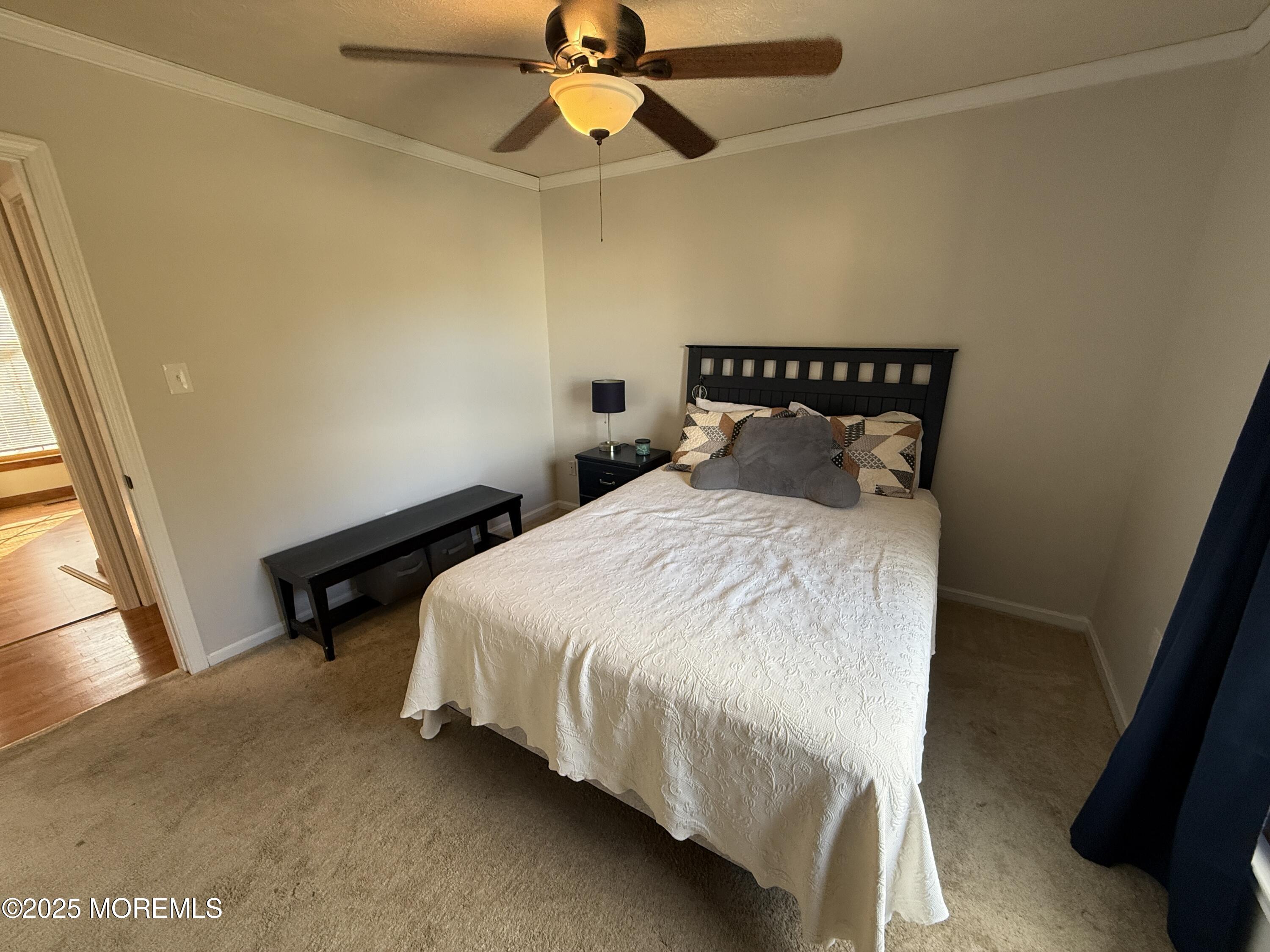 220 B Center Street Tuckerton, NJ 08087 - Photo 23 of 54 a bedroom with a bed and a chandelier