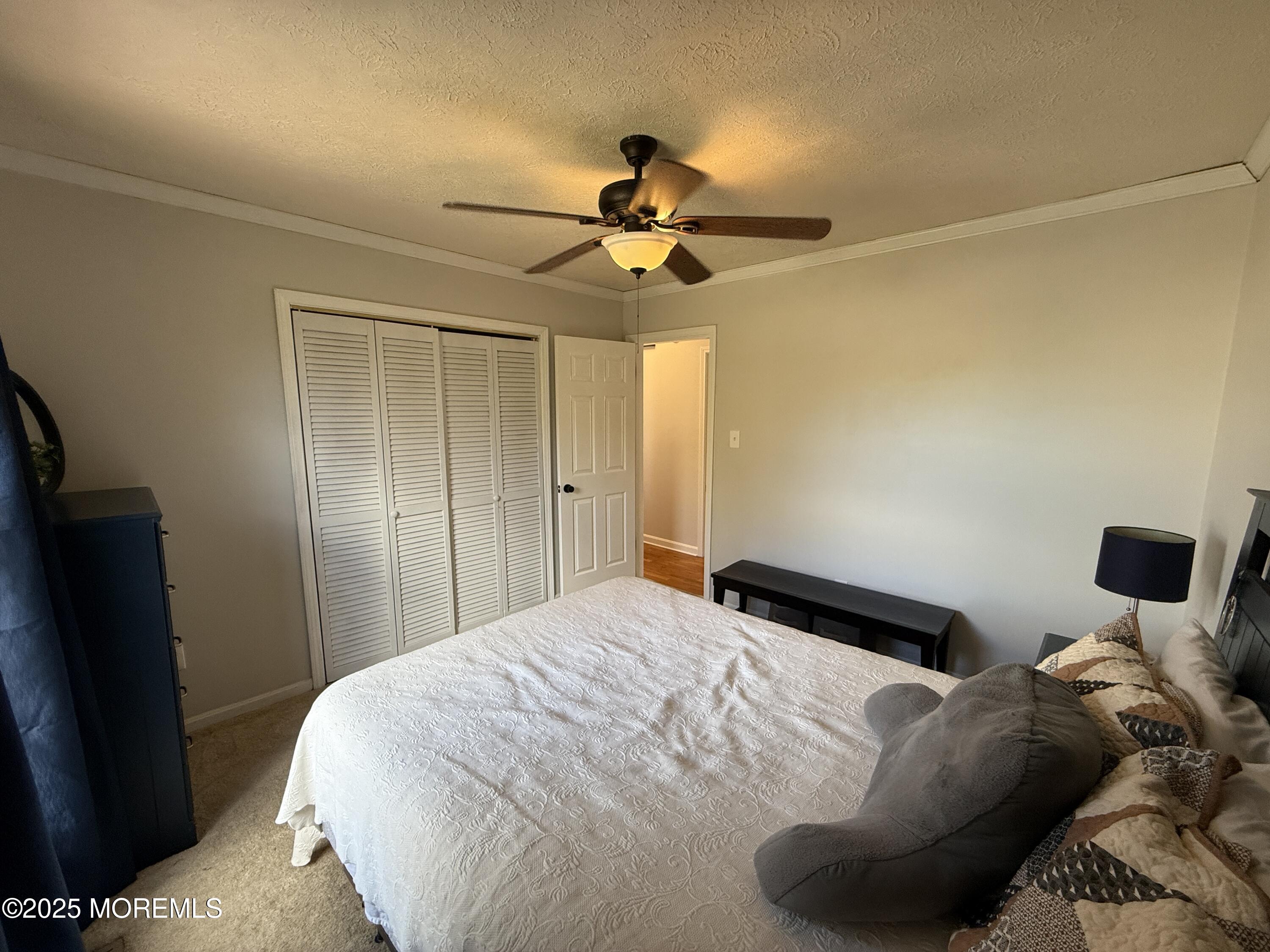 220 B Center Street Tuckerton, NJ 08087 - Photo 24 of 54 a bedroom with a bed and a chandelier