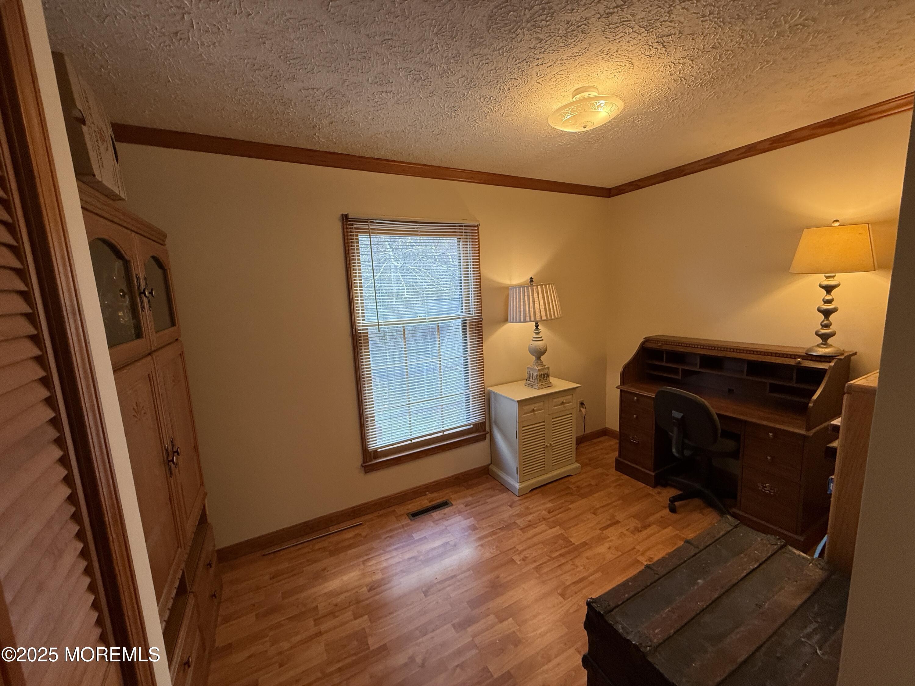 220 B Center Street Tuckerton, NJ 08087 - Photo 25 of 54 a view of an empty room with wooden floor and a window