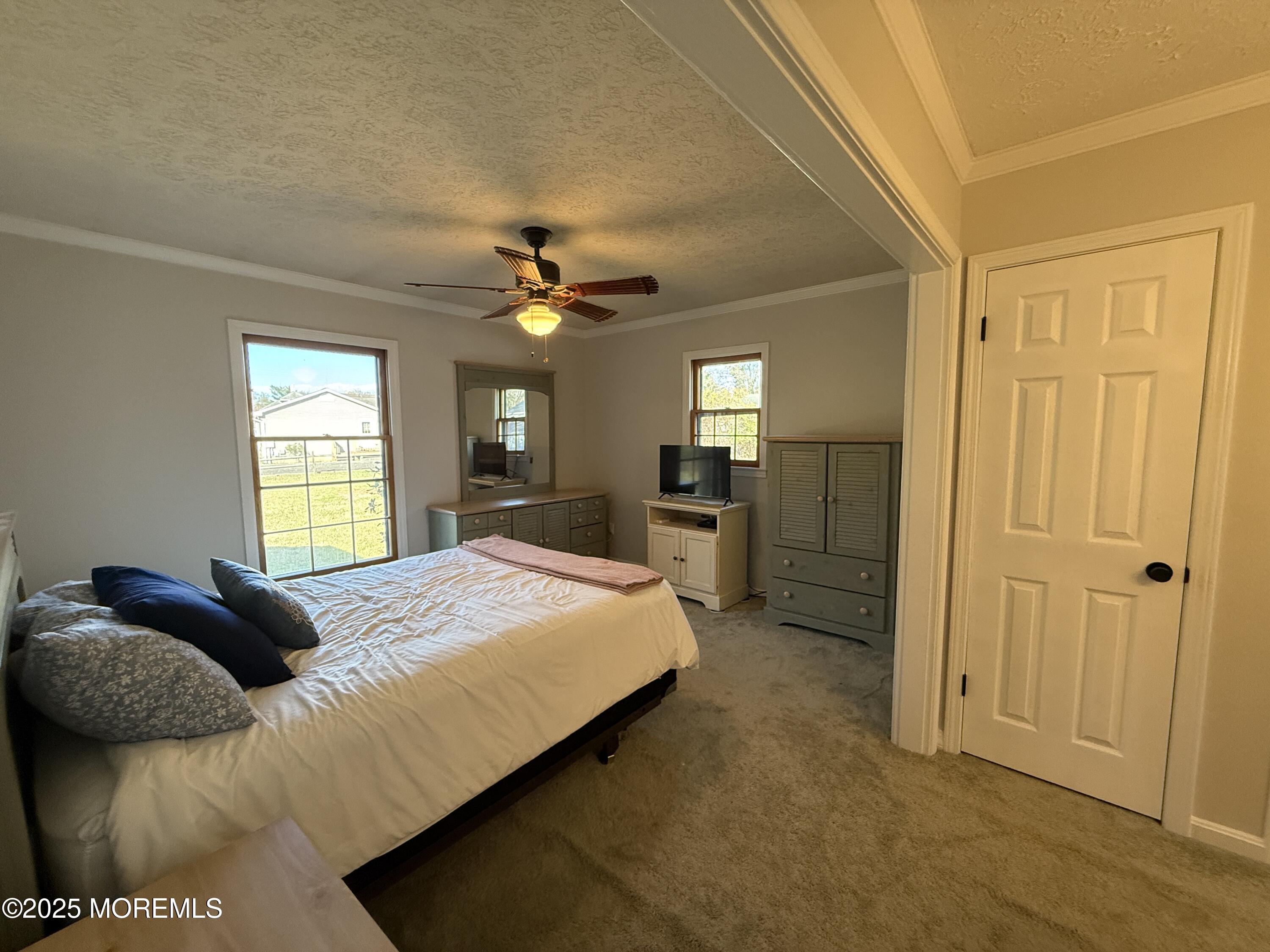 220 B Center Street Tuckerton, NJ 08087 - Photo 32 of 54 a bedroom with a bed and a chandelier