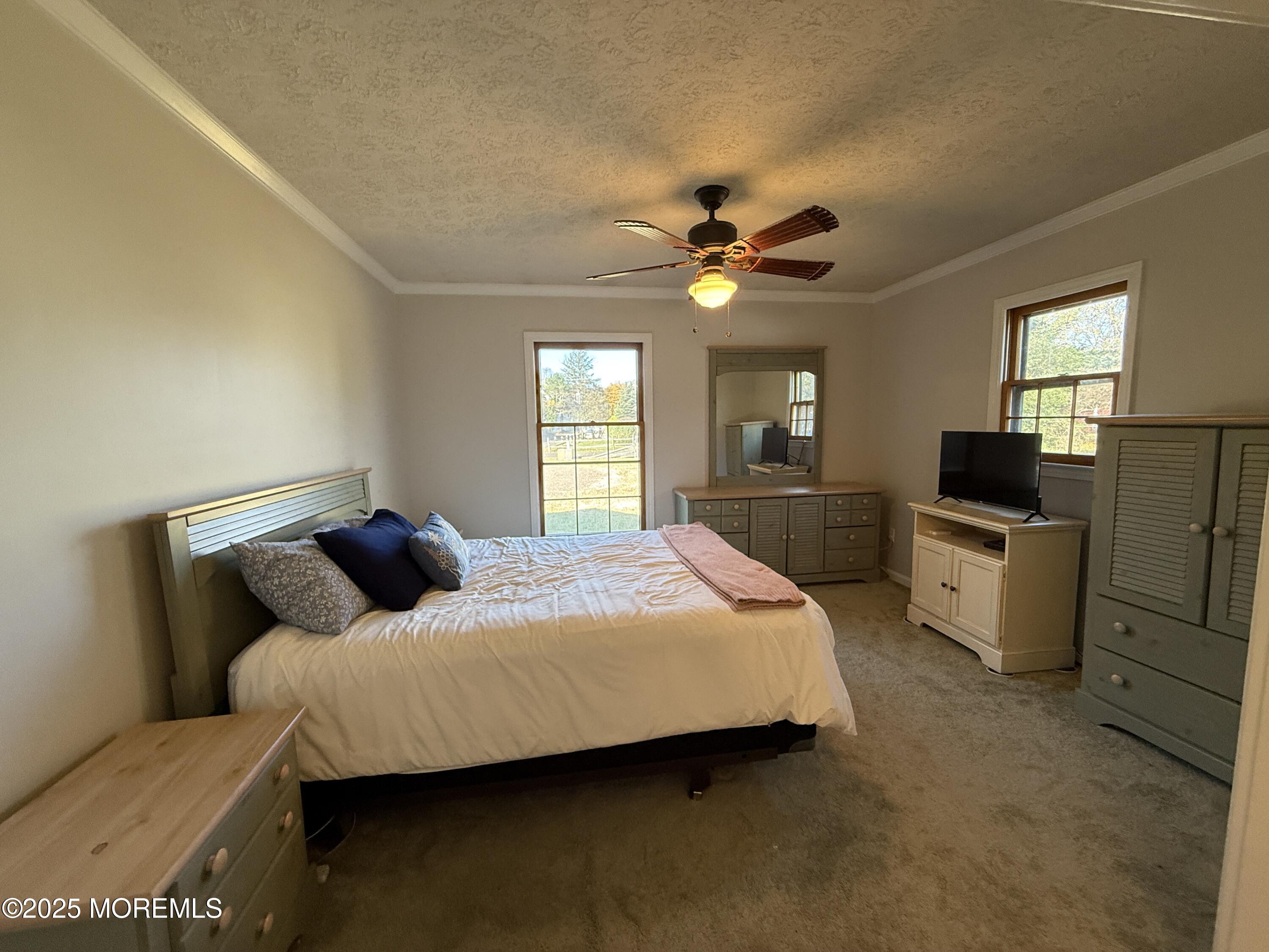220 B Center Street Tuckerton, NJ 08087 - Photo 33 of 54 a bedroom with a bed a couch and dresser