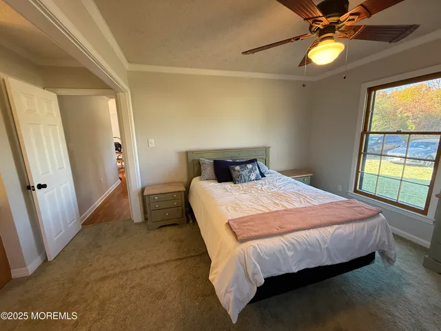 a bedroom with a bed and a large window