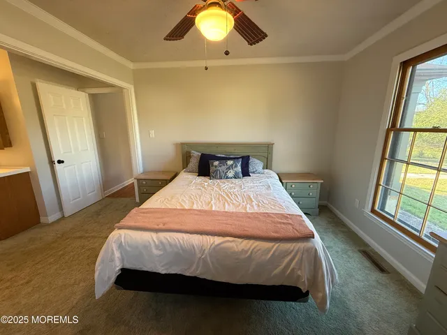 a bedroom with a bed and a sink