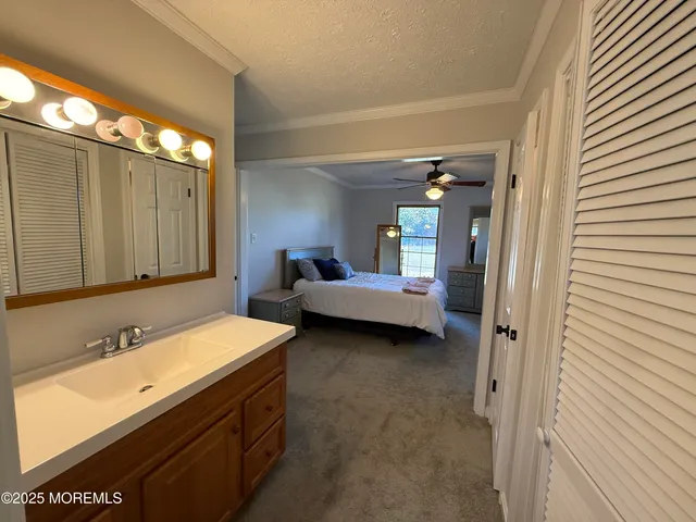 a view of a hallway with closet and bathroom