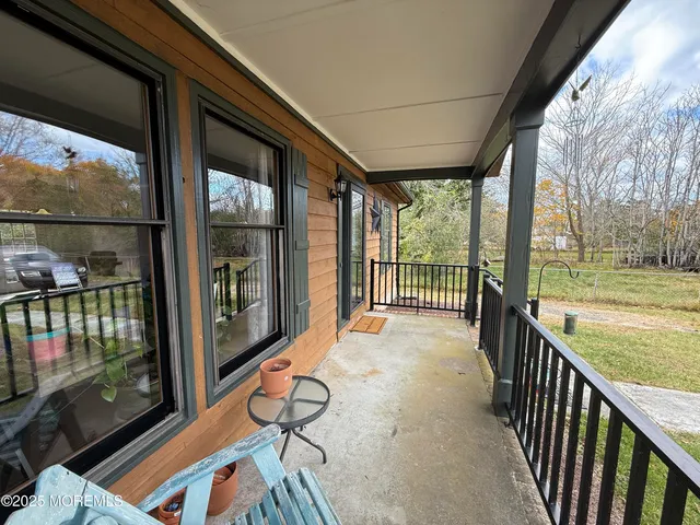 a view of a porch with wooden floor and outdoor space