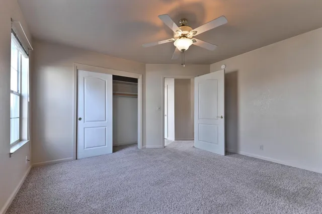 a view of a livingroom with a chandelier fan