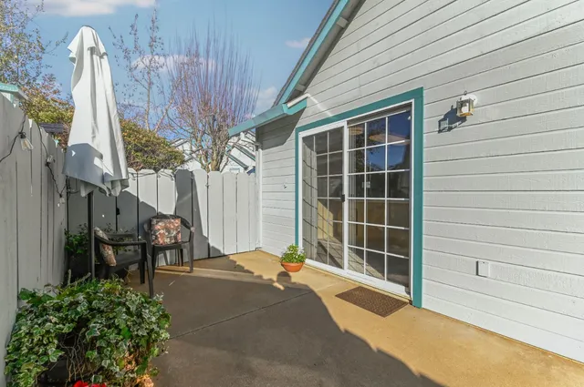 a view of a house with backyard and sitting area