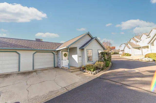 a view of a house with a yard and garage