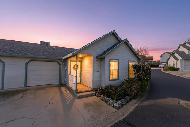 a front view of a house with glass windows and a garage