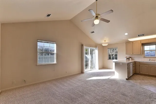 a view of an empty room with window and cabinet