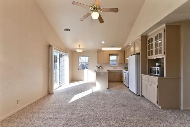 a view of a kitchen with a sink and a refrigerator