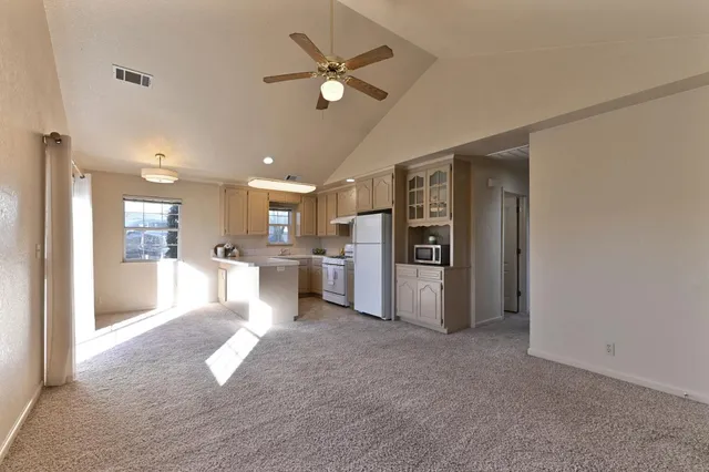 a view of kitchen with furniture and a refrigerator