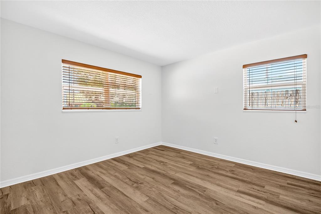 13440 1st Street East Madeira Beach, FL 33708 - Photo 35 of 44 a view of an empty room with wooden floor and a window