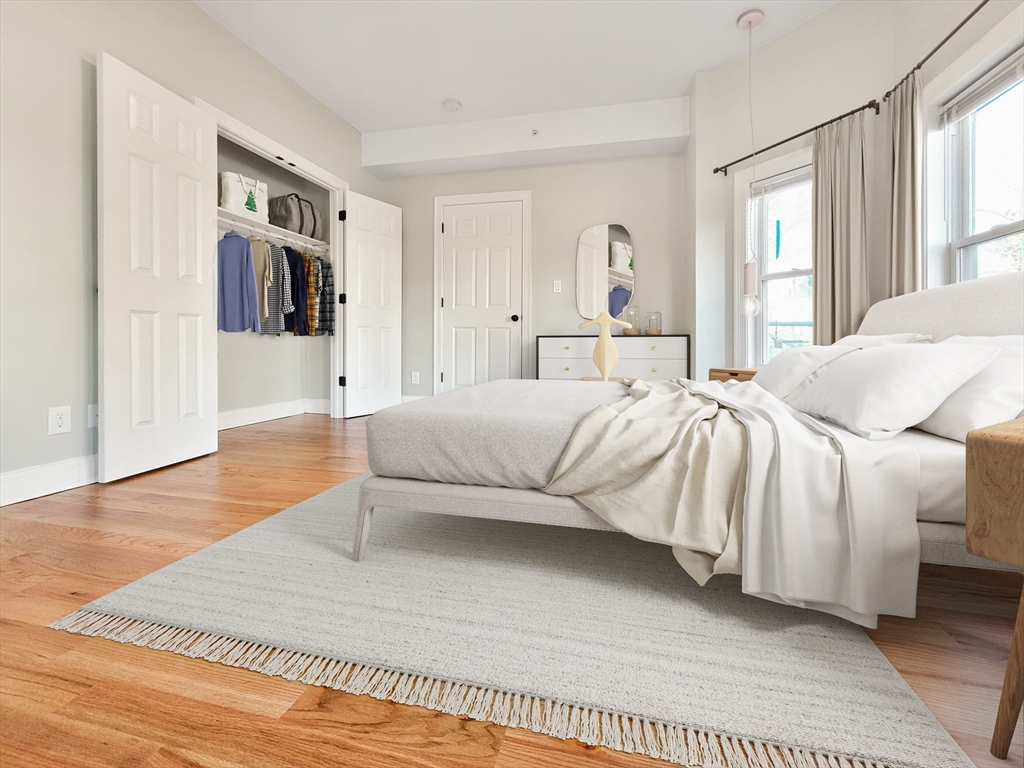 26 Arcadia Street, Unit 1R Boston, MA 02122 - Photo 2 of 7 a bedroom with a large bed and a couch