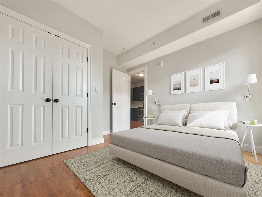 26 Arcadia Street, Unit 1R Boston, MA 02122 - Photo 3 of 7 a spacious bedroom with a bed and a walk in closet