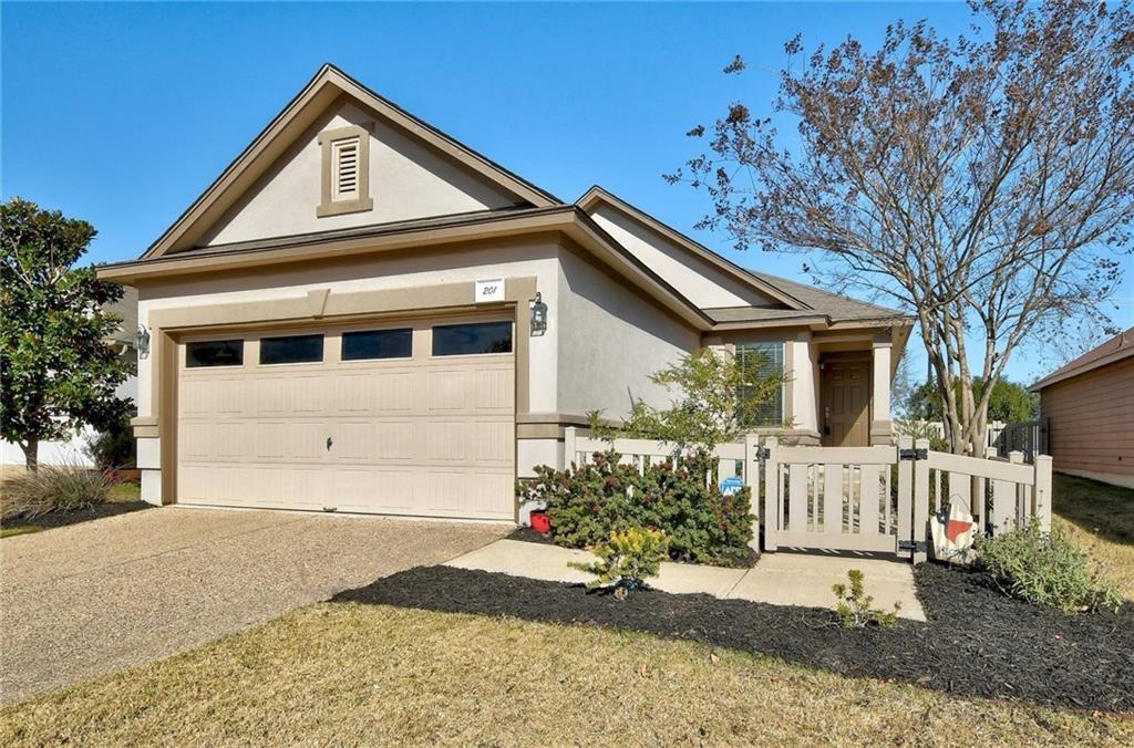 Stucco exterior with a peaked roofline and an attached two-car garage