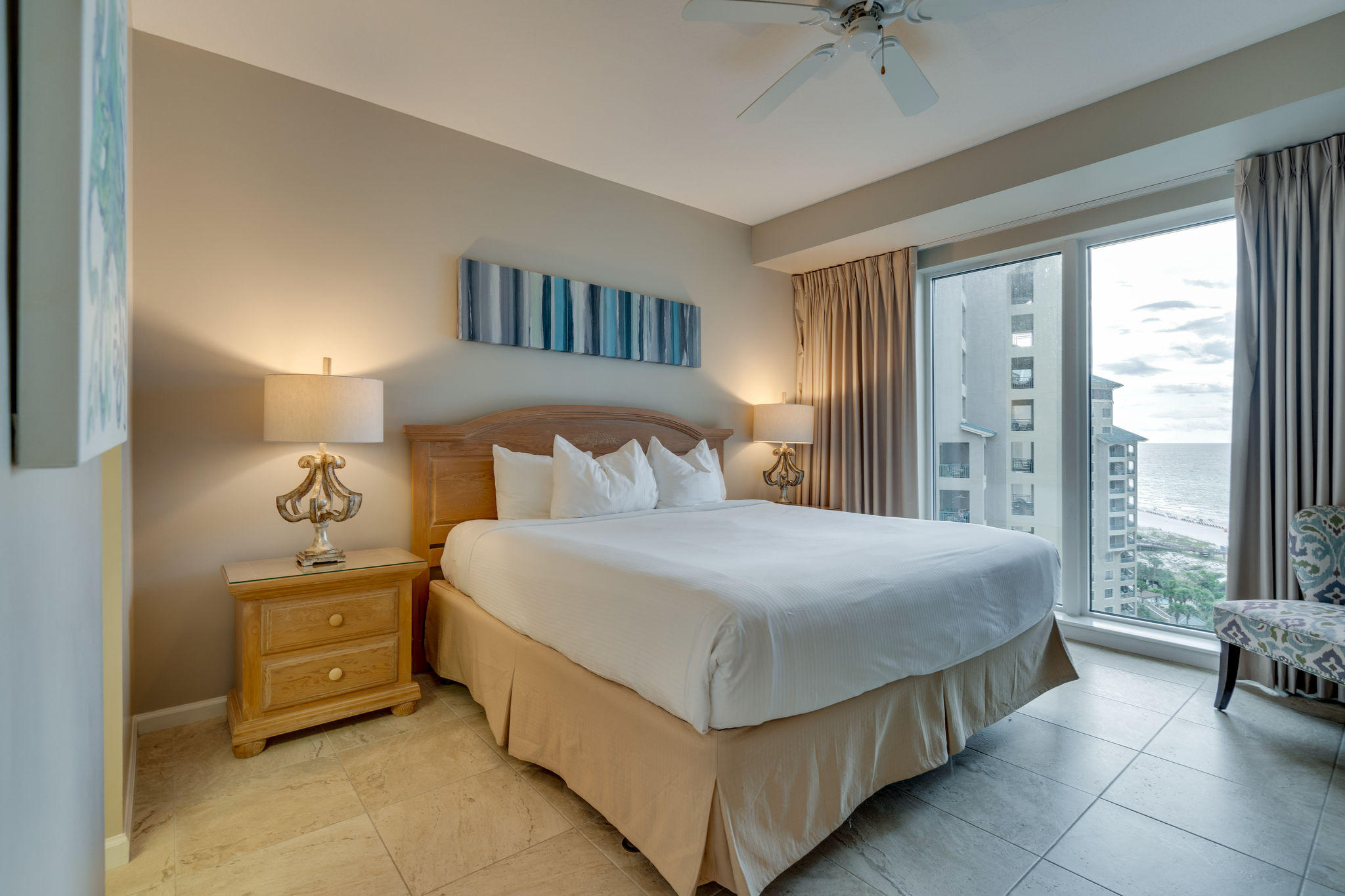 4807 Westwinds Drive, Unit 4807 Miramar Beach, FL 32550 - Photo 13 of 19 a bedroom with a bed and a chandelier