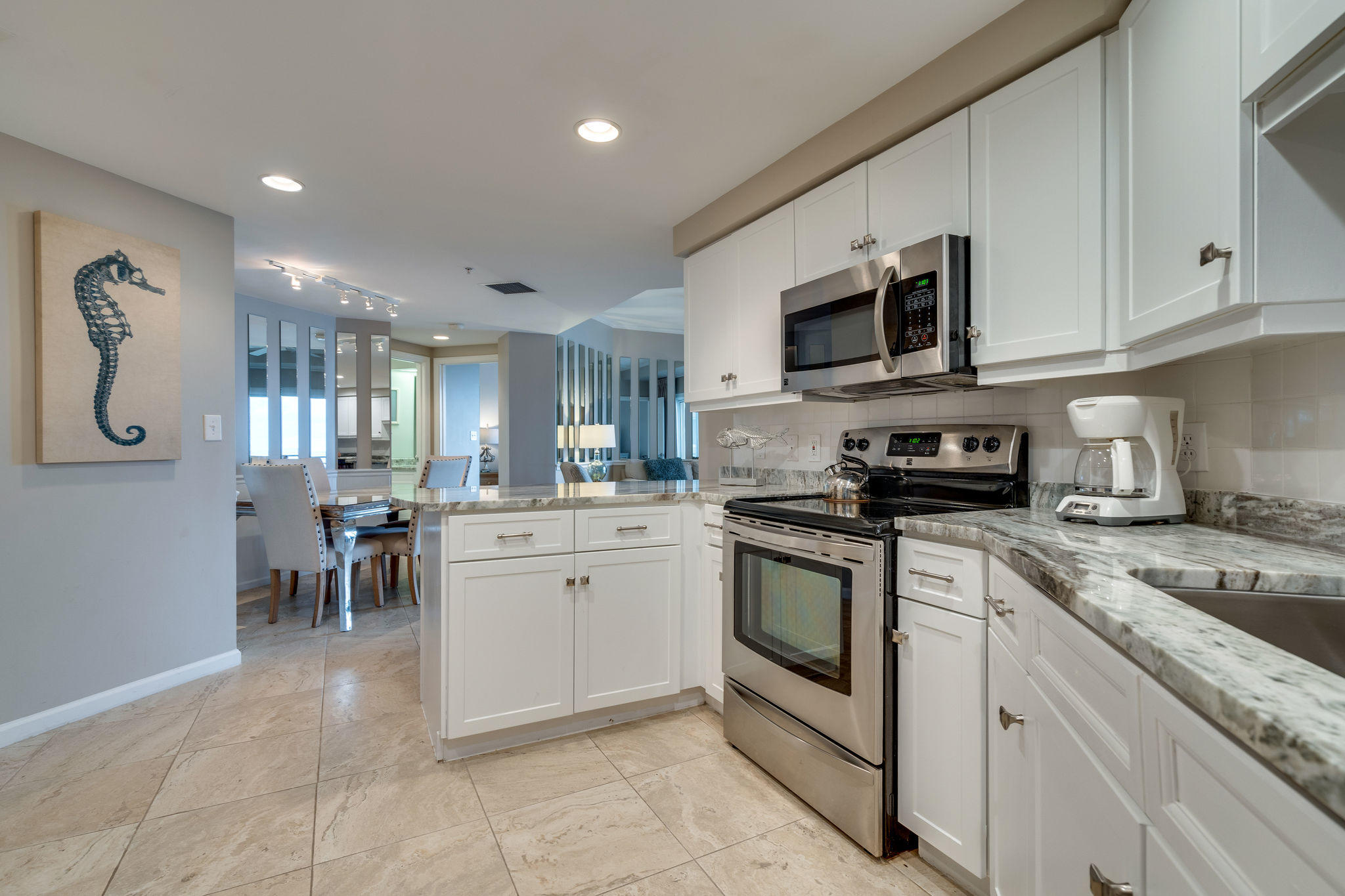 4807 Westwinds Drive, Unit 4807 Miramar Beach, FL 32550 - Photo 6 of 19 a kitchen with appliances cabinets and a sink