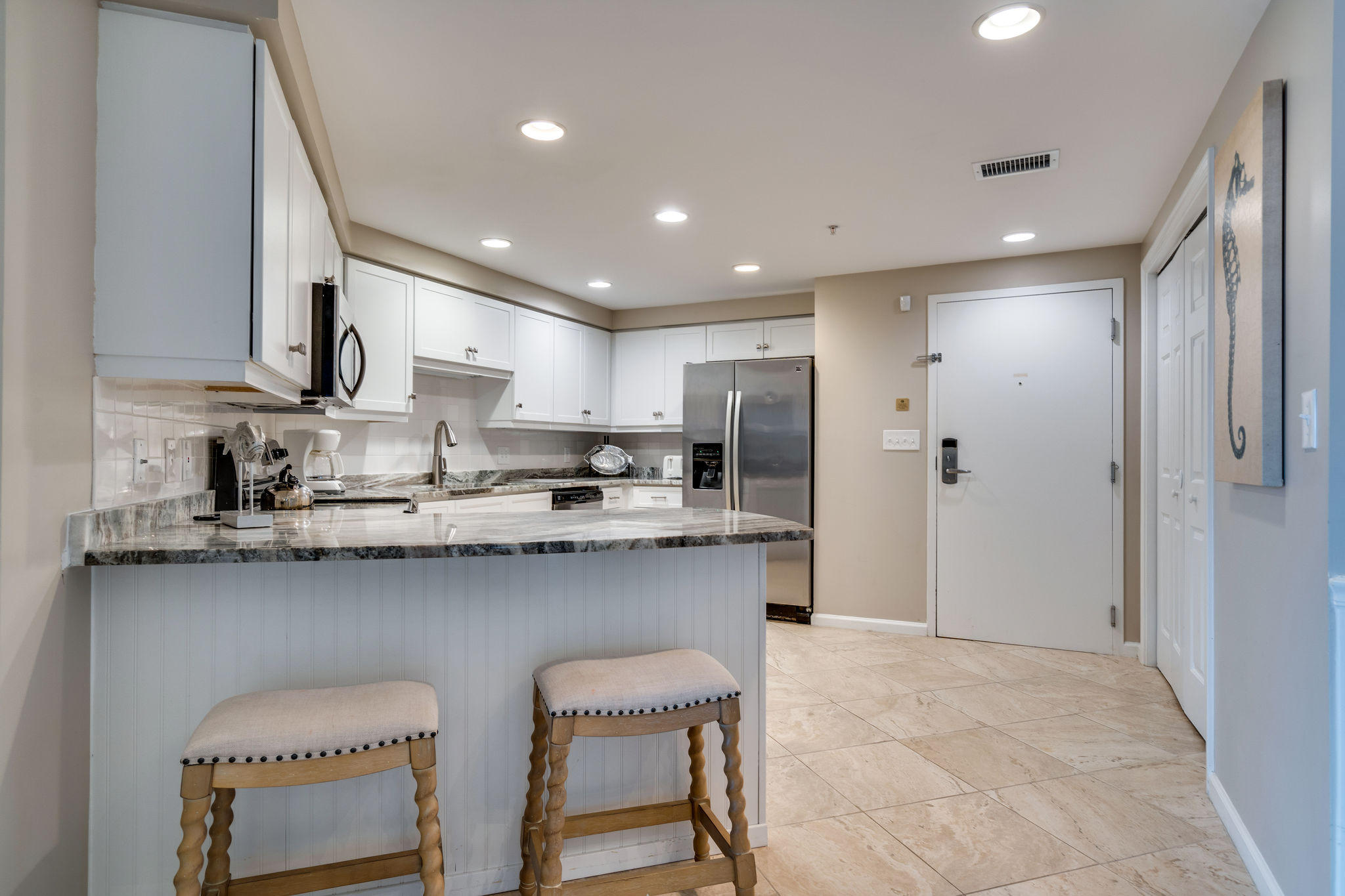 4807 Westwinds Drive, Unit 4807 Miramar Beach, FL 32550 - Photo 8 of 19 a kitchen with stainless steel appliances granite countertop a sink and a refrigerator