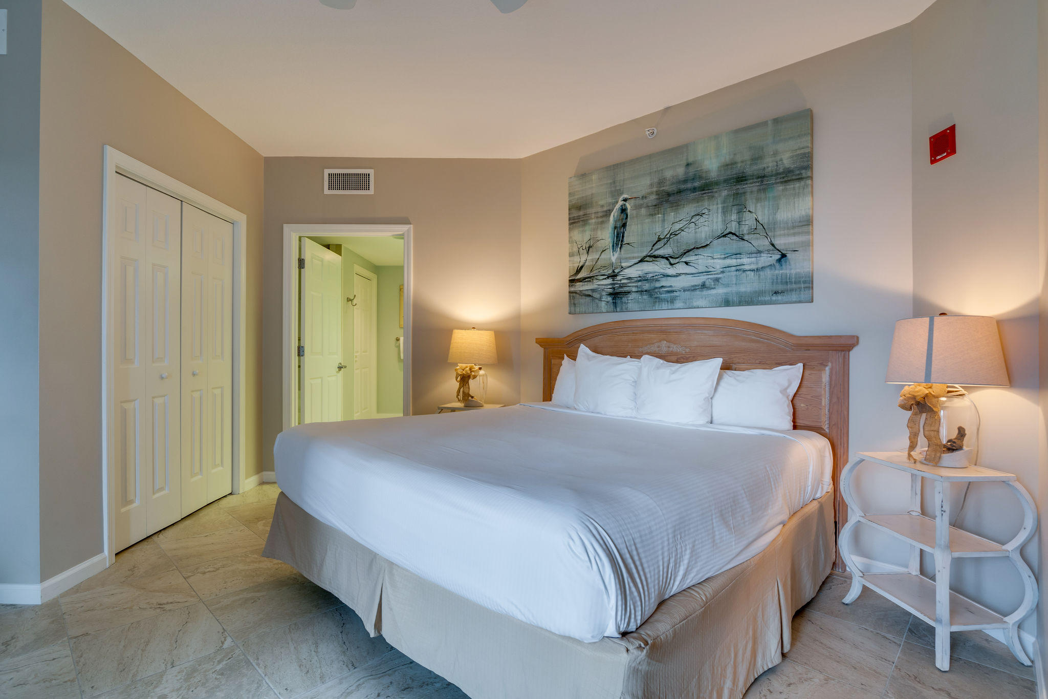 4807 Westwinds Drive, Unit 4807 Miramar Beach, FL 32550 - Photo 9 of 19 a bedroom with a bed and lamp