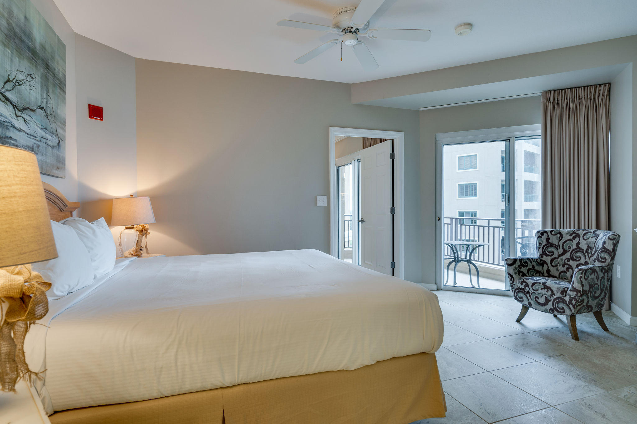 4807 Westwinds Drive, Unit 4807 Miramar Beach, FL 32550 - Photo 10 of 19 a bedroom with a bed and a chandelier