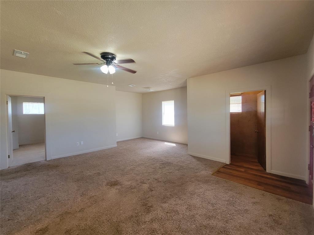215 Cedar Court Graham, TX 76450 - Photo 13 of 39 an empty room with fan and windows