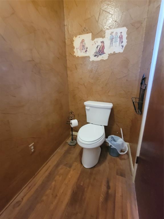 215 Cedar Court Graham, TX 76450 - Photo 16 of 39 a white toilet sitting next to a sink