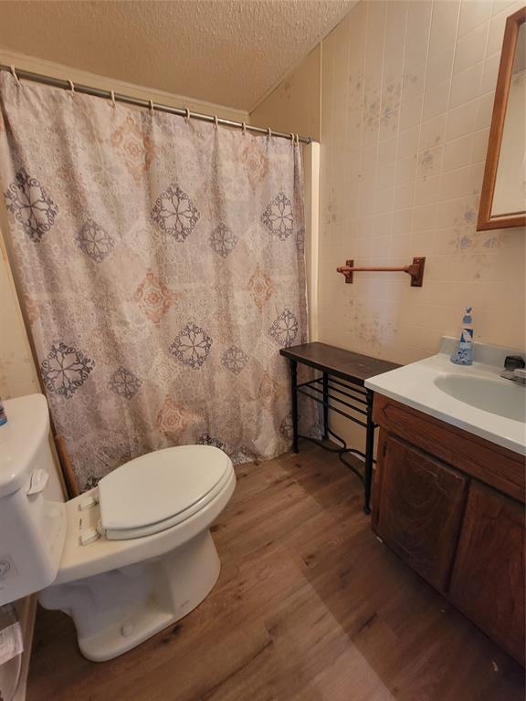 215 Cedar Court Graham, TX 76450 - Photo 20 of 39 a white toilet sitting next to a bathroom sink