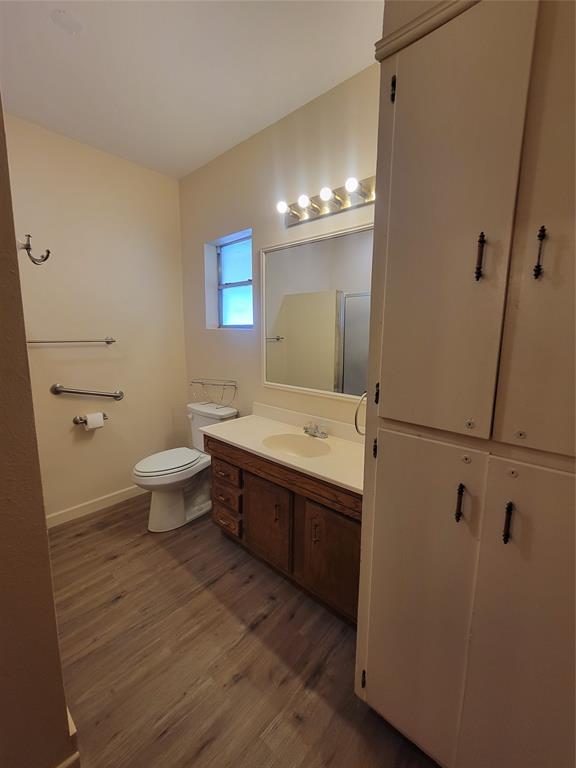 215 Cedar Court Graham, TX 76450 - Photo 27 of 39 a bathroom with a sink a toilet and mirror